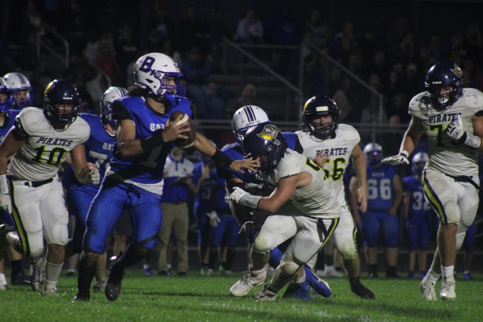 Bath senior quarterback Brayden Bennett ( looks to throw against the Pewamo-Westphalia defense during a varsity football game Thursday, Aug. 31, at Bath High School. P-W won the game, 21-0.