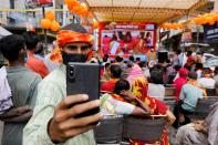 A Hindu man takes a selfie during a live screening of the stone laying ceremony of the Ram Temple by Prime Minister Narendra Modi in Ayodhya, in New Delhi