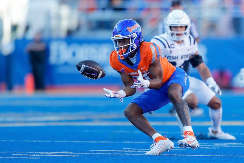 Boise State wide receiver Cameron Bates (80) turns to catch the ball in front of a Utah State defender in the first half of an NCAA college football game, Saturday, Oct. 5, 2024, in Boise, Idaho. . (AP Photo/Steve Conner) | Steve Conner