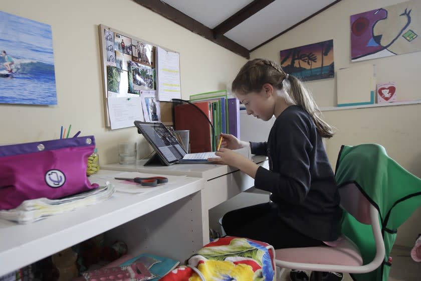 Rachel Keenan, 9, takes a live class online at her home in San Francisco last March.