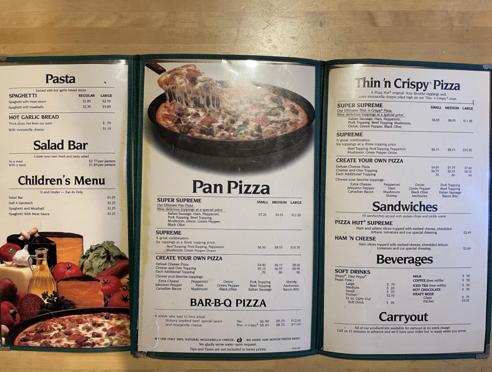 The image shows a restaurant menu featuring pasta, salad bar, children's menu, pan pizza, thin n crispy pizza, sandwiches, beverages, and carryout options