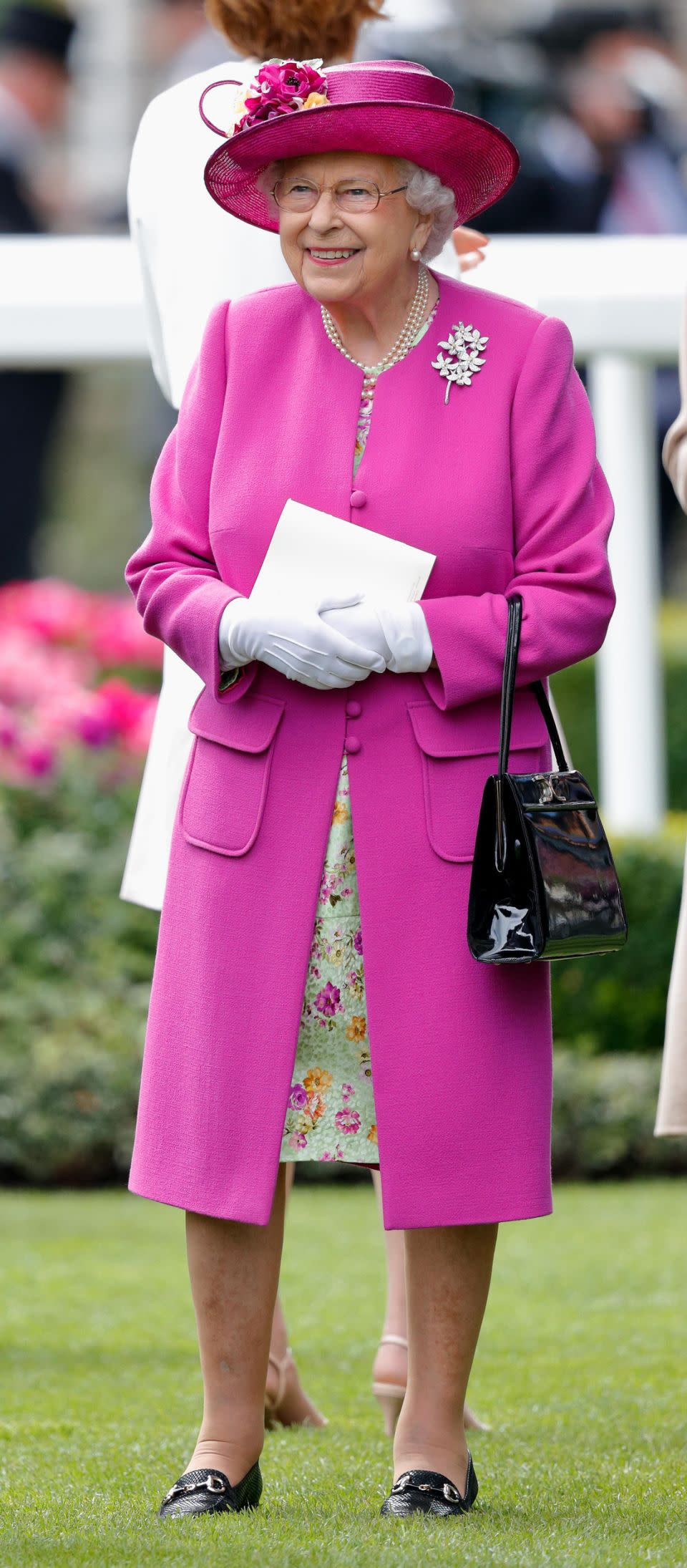 Her Majesty always makes sure she stands out in a crowd. Photo: Getty