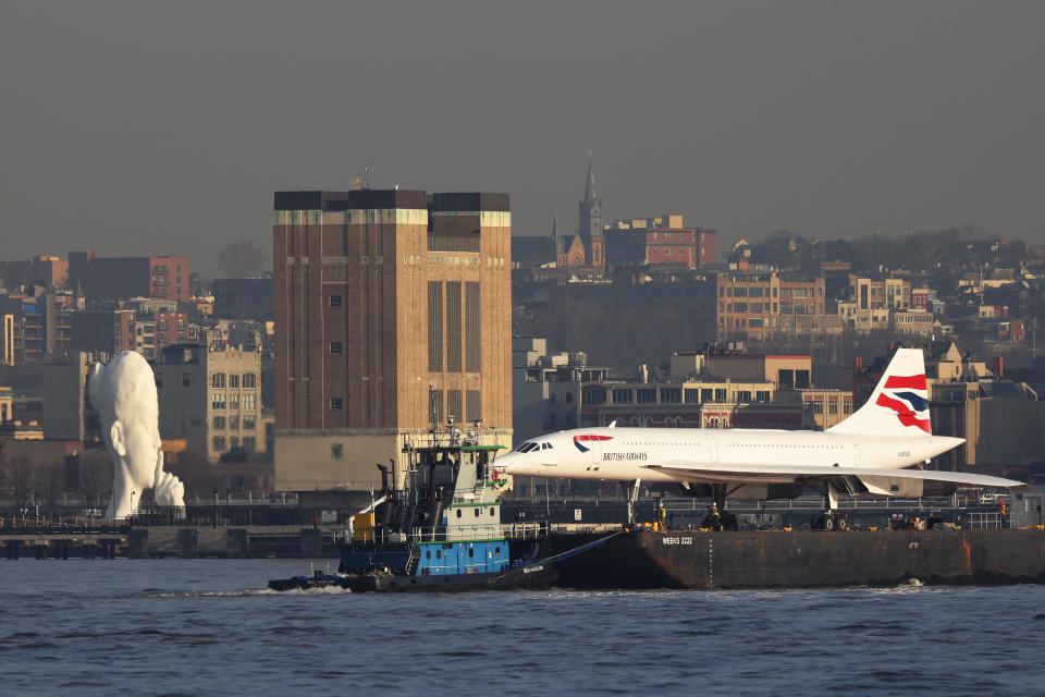 A retired British Airways Concorde supersonic airliner is moved by a barge on the Hudson River on March 14, 2024 in New York City.