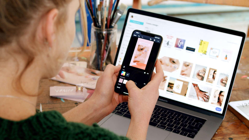 person using Canva platform on mobile phone and desktop