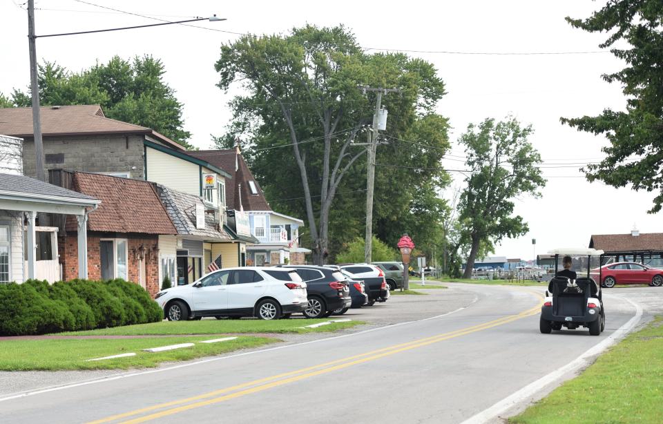 An islander drives a golf cart down South Channel Drive in Sans Souci on Tuesday, Aug. 1, 2023. The Clay Township corridor is the focus of a new nonprofit formed to help revitalize the site and whose members are among those hoping a new wastewater treatment plant to get the area off septic will help.