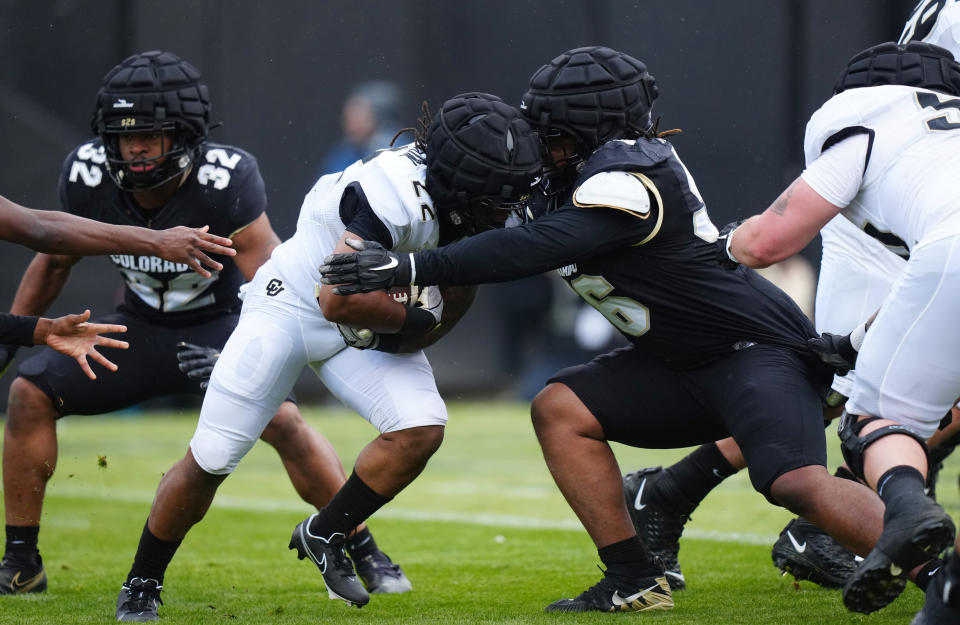 Apr 22, 2023; Boulder, CO, USA; Colorado Buffaloes defensive lineman Mason Maddox (56) tackles running back Anthony Hankerson (22) during the first half of a spring game at Folsom Filed. Mandatory Credit: Ron Chenoy-USA TODAY Sports