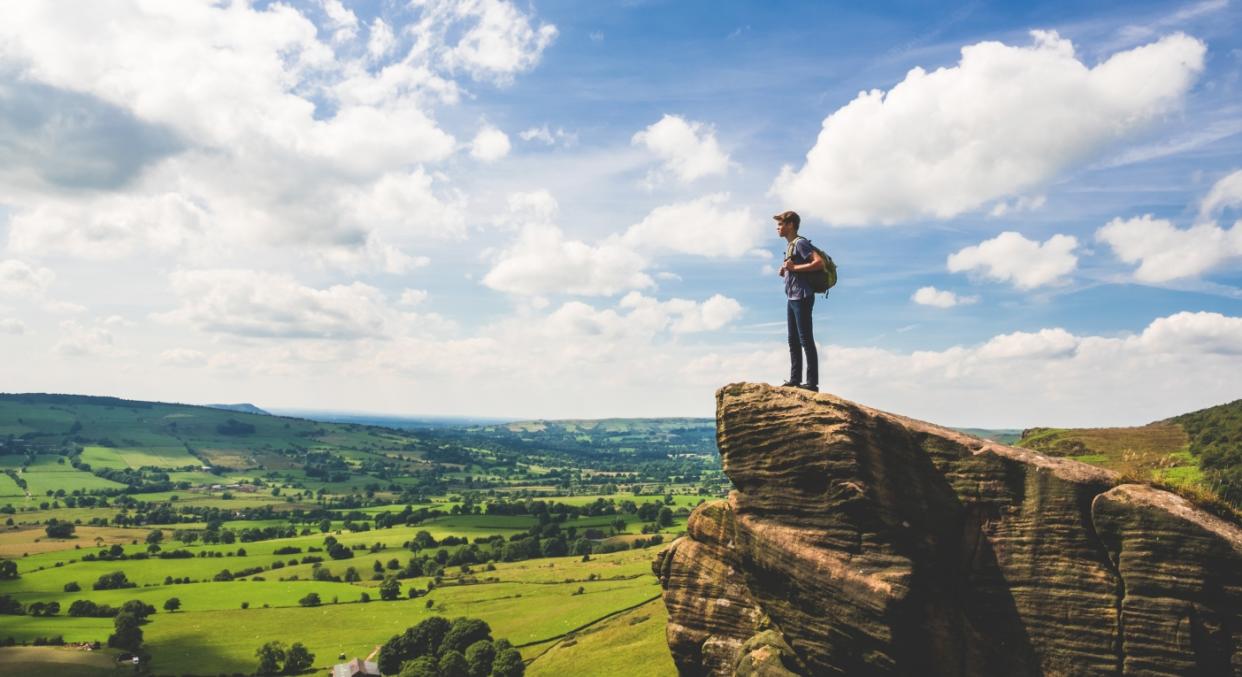 A man standing atop The Roaches in the Peak District National Park (Getty)