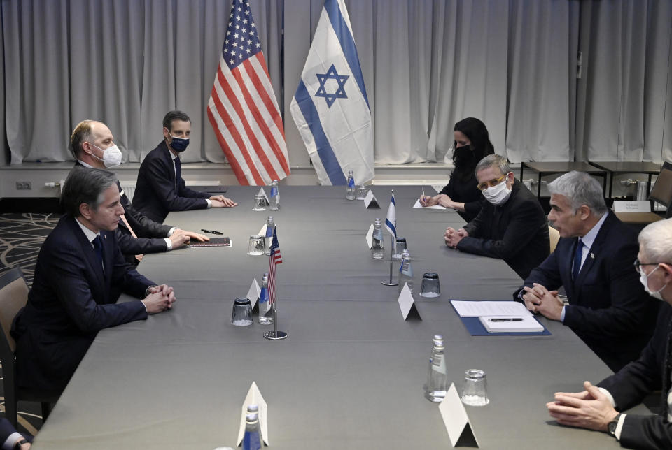 US Secretary of State Antony Blinken, left, meets with Israeli Foreign Minister Yair Lapid, second right, in Riga, Latvia, Monday, March 7, 2022. U.S. Secretary of State Antony Blinken visited Lithuania and Latvia on Monday to calm any fears that they and Estonia, which he'll visit Tuesday, have about their security in the event Russia chooses to expand its military operations. (Olivier Douliery/Pool via AP)