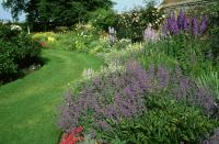 <p>A herbaceous and beautiful border of catmint, delphinium, red-hot poker, and roses cover this garden.</p><p><strong><a href="https://www.countryliving.com/gardening/g4195/best-fragrant-outdoor-plants/" rel="nofollow noopener" target="_blank" data-ylk="slk:Find more fragrant flowers to plant;elm:context_link;itc:0;sec:content-canvas" class="link ">Find more fragrant flowers to plant</a>.</strong></p><p><a class="link " href="https://go.redirectingat.com?id=74968X1596630&url=https%3A%2F%2Fwww.etsy.com%2Fsearch%3Fq%3Dcatmint&sref=https%3A%2F%2Fwww.countryliving.com%2Fgardening%2Fgarden-tours%2Fg1432%2Flandscaping-ideas%2F" rel="nofollow noopener" target="_blank" data-ylk="slk:SHOP CATMINT;elm:context_link;itc:0;sec:content-canvas">SHOP CATMINT</a></p>