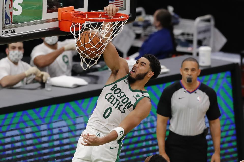 Boston Celtics' Jayson Tatum (0) dunks during the first half of an NBA basketball game against the Brooklyn Nets, Friday, Dec. 25, 2020, in Boston. (AP Photo/Michael Dwyer)