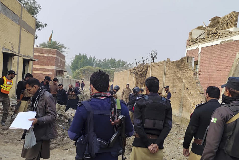 Security officials examine damages on the site of a bombing at a police station on the outskirts of Dera Ismail Khan, Pakistan, Tuesday, Dec. 12, 2023. A suicide bomber detonated his explosive-laden vehicle at a police station's main gate in northwest Pakistan on Tuesday, killing several policemen and wounding more than dozen others, officials said. Some militants also opened fire and a shootout between them and security forces was still ongoing, police officer Kamal Khan said. (AP Photo)