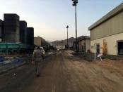 A member of the Saudi security forces walks near the fire damaged Saudi Electricity Company plant in eastern Najran city, after a Houthi rocket attack, Saudi Arabia August 27, 2016. REUTERS/Katie Paul