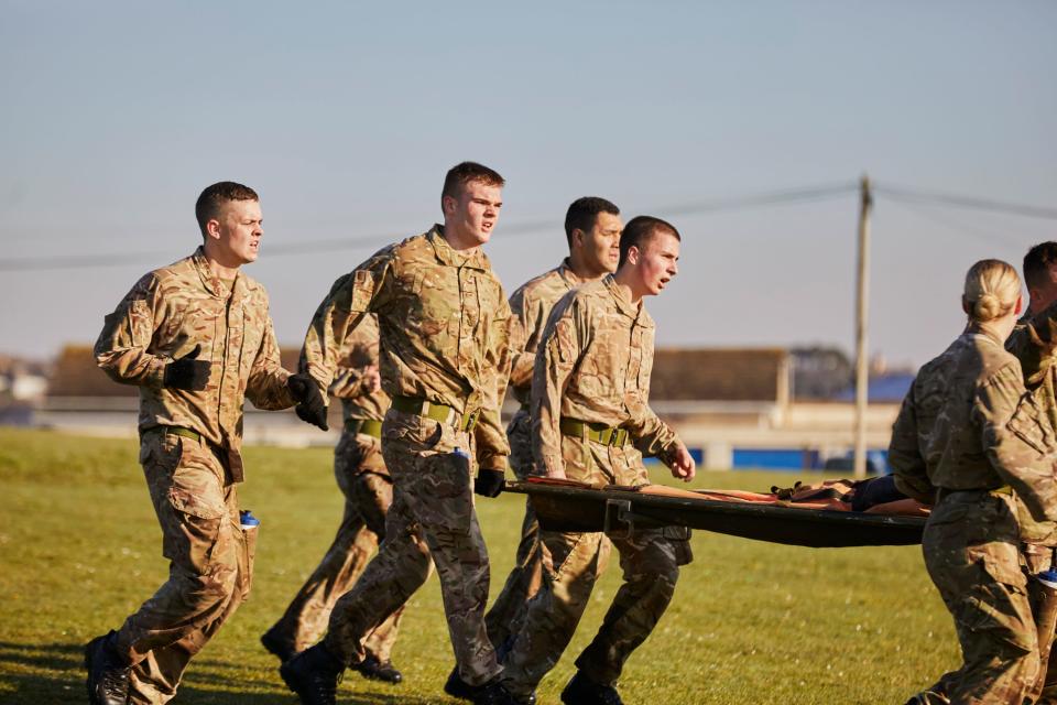 Recruits at HMS Raleigh doing the stretcher run.