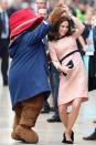 <p>Duchess Kate dances with Paddington Bear as she arrives at the Charities Forum Event at Paddington Station with Prince William.</p>