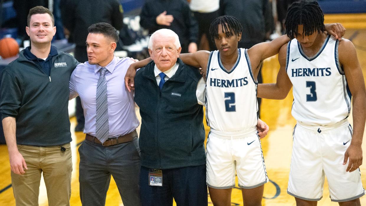 St. Augustine boys basketball coach Paul Rodio, center, stands with his players and members of his coaching staff as the national anthem is played prior to the game between St. Augustine and Eastside played at St. Augustine Prep in Richland on Tuesday, January 3, 2023.  