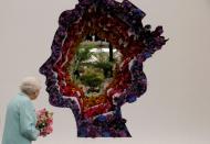 <p>The Queen looks at a beautiful floral exhibit in her honour designed by the New Covent Garden Flower Market in 2016.</p>