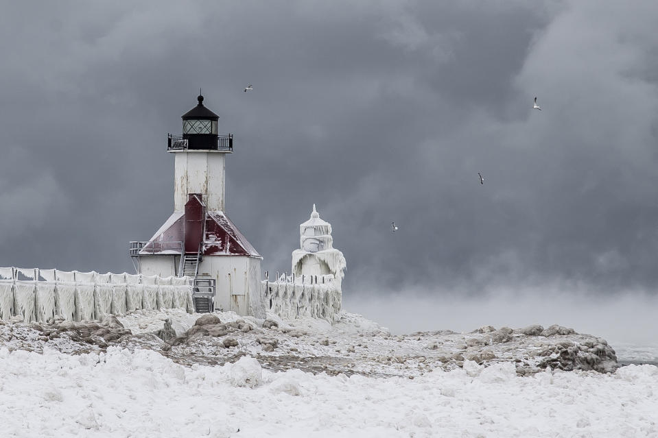 SOUTH HAVEN, MI - JANUARY 8: St Joseph's Lighthouse above a frozen lake, in South Haven, Michigan.ICE engulfs a red lighthouse as a fierce winter storm grips South Haven, Michigan. Sharp icicles and surreal formations can be seen hanging from the railings after strong waves crashed onto the piers. After each coating the water quickly freezes to ice and the pier is transformed into a slippery, white wonderland. Weather in the area dipped into the minus figures and froze over Lake Michigan in the beginning of January.PHOTOGRAPH BY Mike Kline / Barcroft MediaUK Office, London.T +44 845 370 2233W www.barcroftmedia.comUSA Office, New York City.T +1 212 796 2458W www.barcroftusa.comIndian Office, Delhi.T +91 11 4053 2429W www.barcroftindia.com