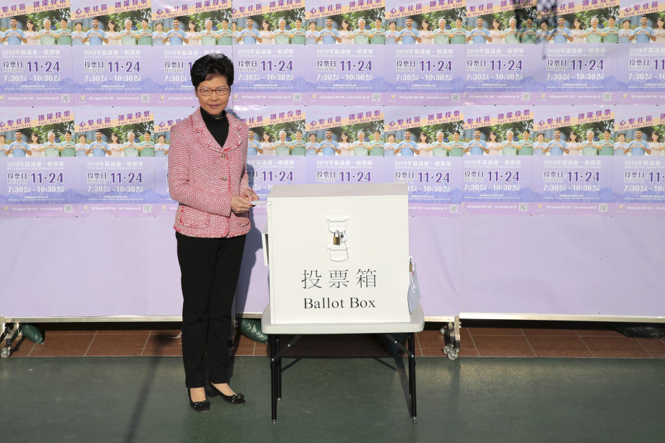 Hong Kong Chief Executive Carrie Lam casts her ballot at a polling place in Hong Kong, Sunday, Nov. 24, 2019. Voting was underway Sunday in Hong Kong elections that have become a barometer of public support for anti-government protests now in their sixth month. (AP Photo/Kin Cheung)