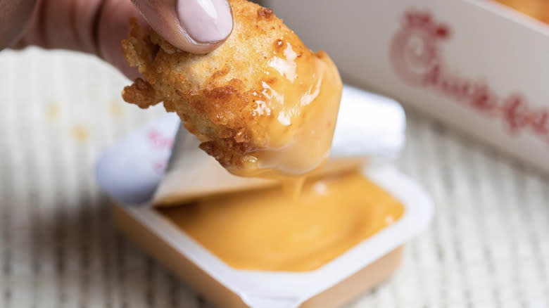 Nugget being dipped in sauce