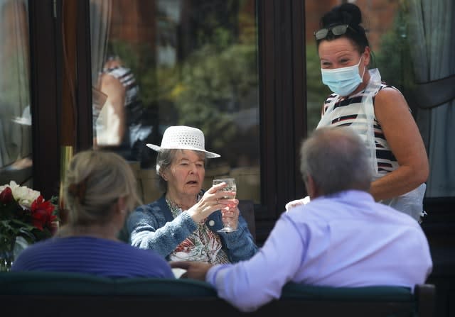 Margaret Yeoman, 90, sees her son John Yeoman, 62, and his wife Denise Yeoman, 63, for the first time in eight weeks as they visit her at the Eothen Homes care home in Whitley Bay, Tyneside, their first in person contact since lockdown began.