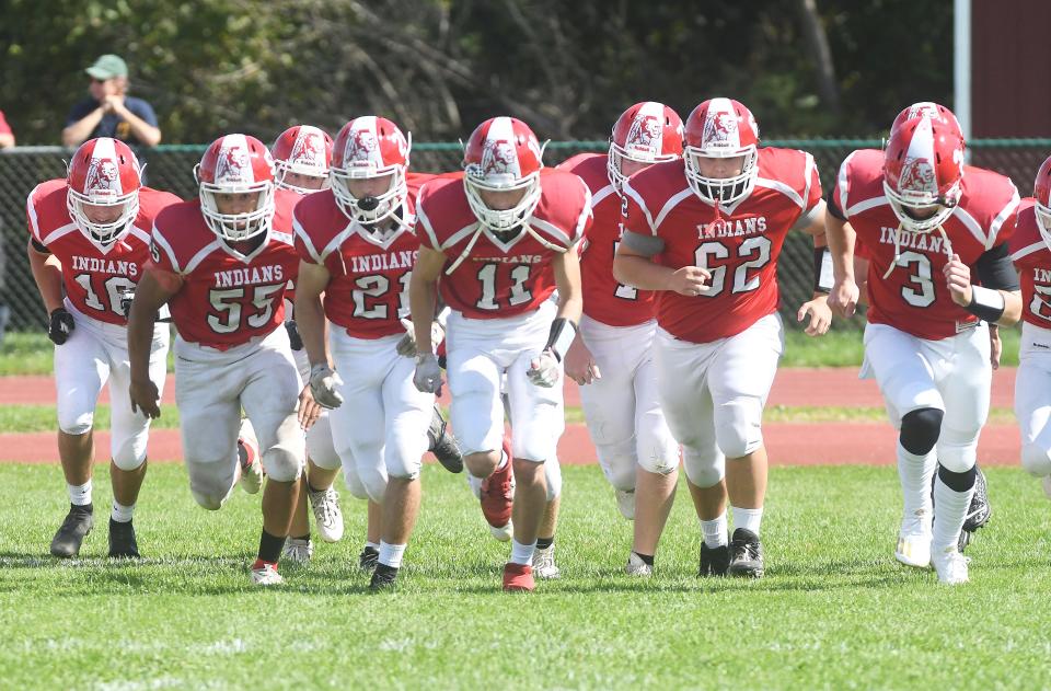 Red Jacket's 8-man football team, as the squad runs on to the field during pre-game for a matchup against Pembroke in 2021.