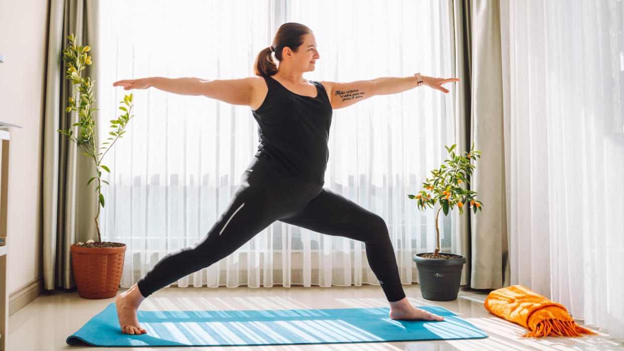  Woman practicing yoga at home 