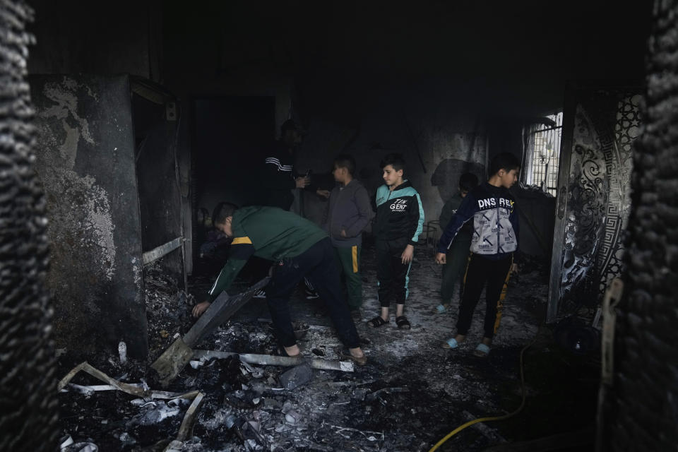 Palestinians inspect a damaged house following an Israeli army operation in Jenin, West Bank, Wednesday, Dec. 13, 2023. (AP Photo/Majdi Mohammed)