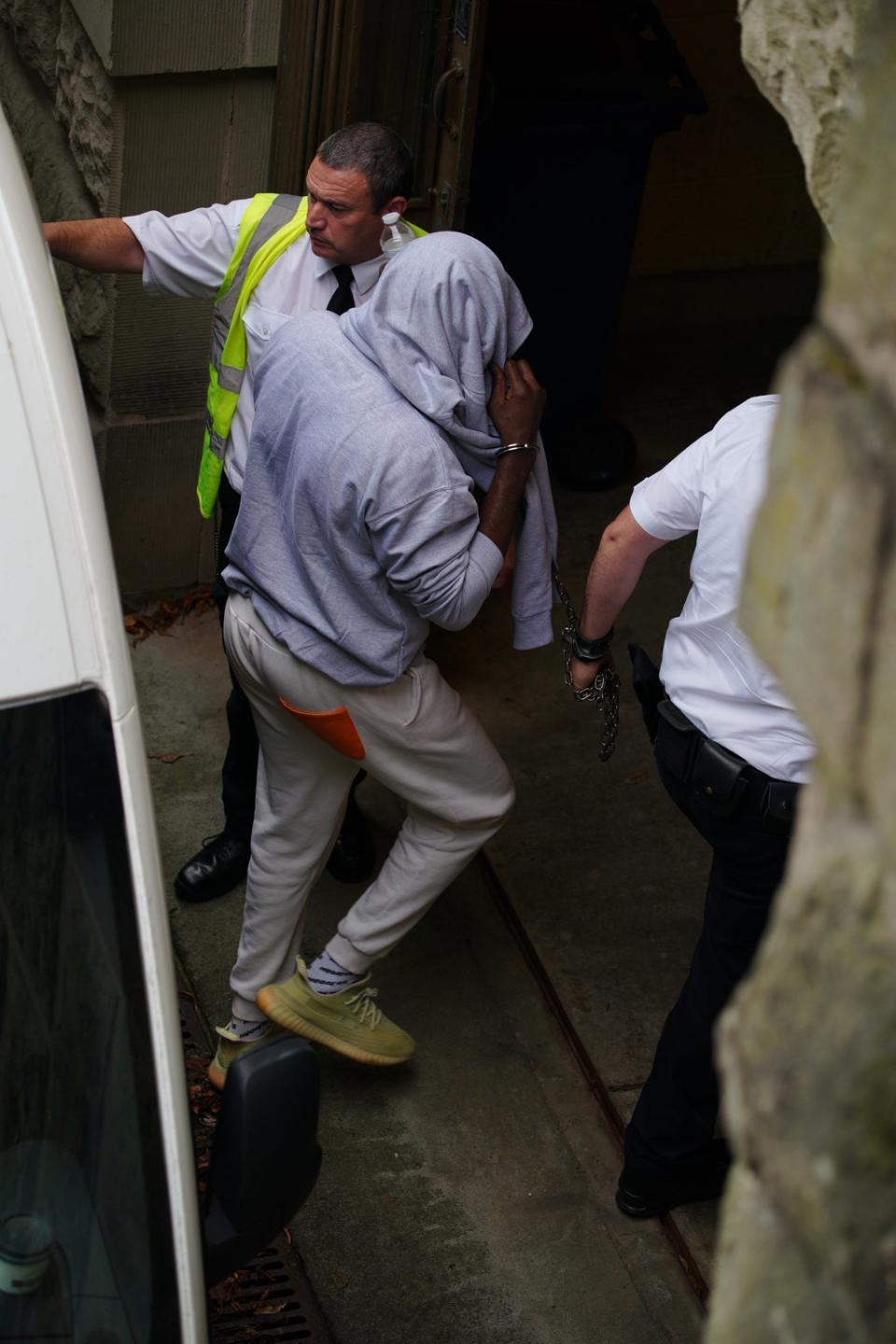 A man believed to be co-defendant Louis Saha Matturie gets out of a prison van at Chester Crown Court at an earlier hearing (PA) (PA Wire)