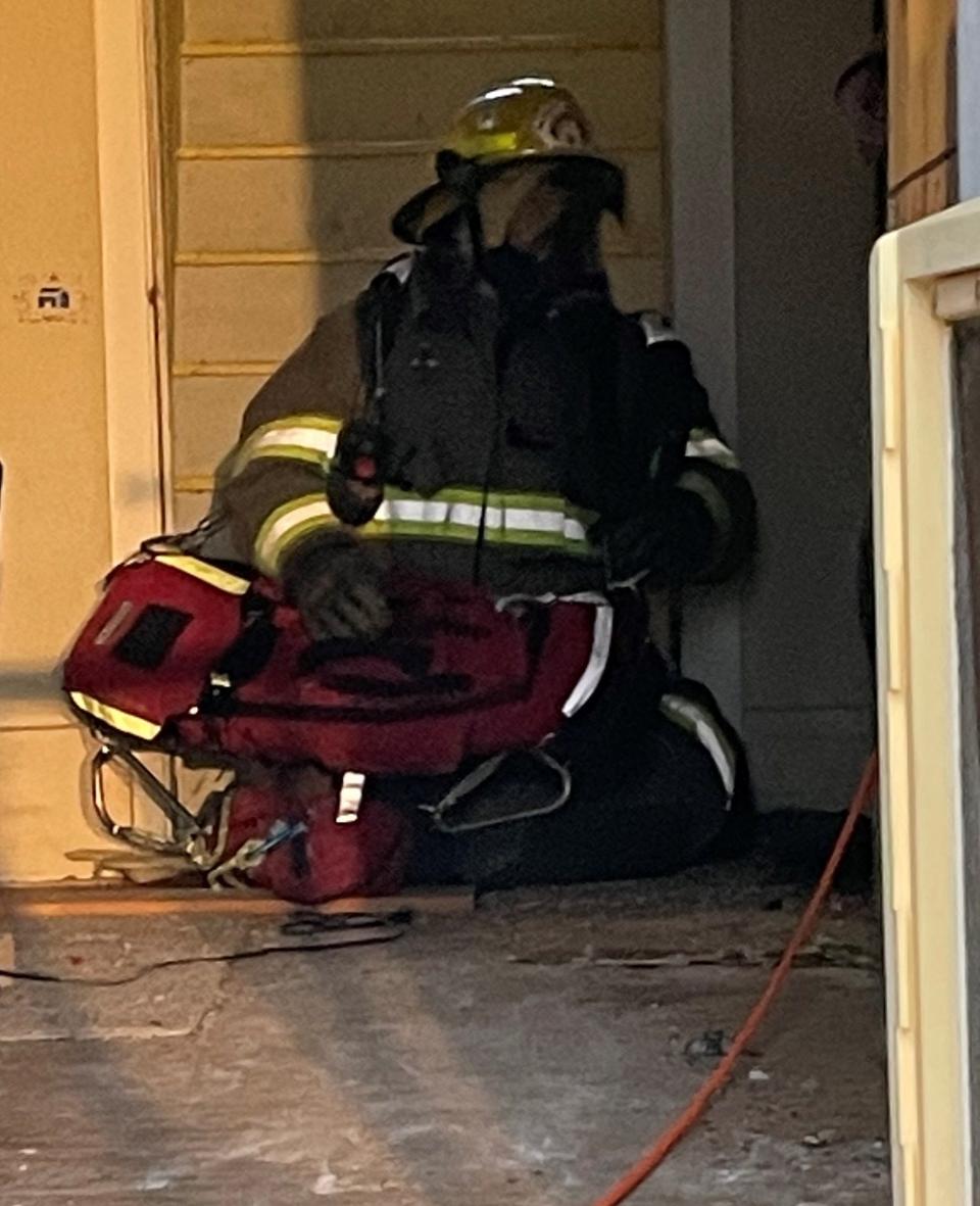 A Central Wood County Rapids Intervention Team practices Monday on how to remove a fallen firefighter from a burning building in Wisconsin Rapids.