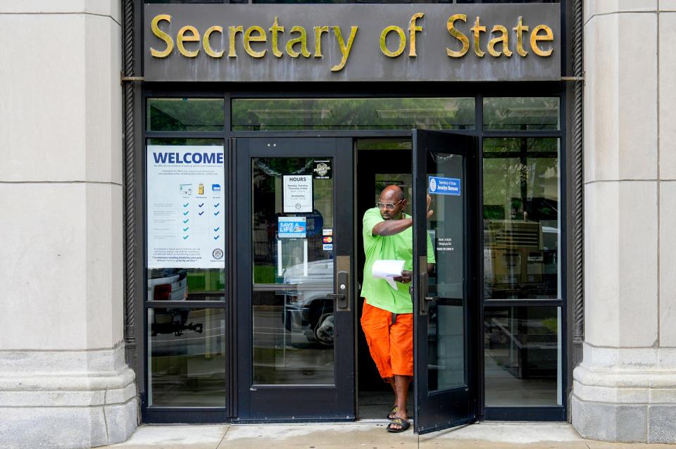 Andrew Johnson, 52, of Detroit exits the Michigan Secretary of State office on West Grand Blvd. in the New Center area of Detroit after renewing his tags on Friday, July 12, 2024. Johnson is paying $800 a month for three cars.