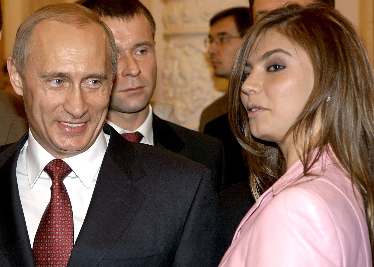 Russian President Vladimir Putin (L) smiles next to Russian gymnast Alina Kabaeva during a meeting with the Russian Olympic team at the Kremlin in Moscow, Russia in this November 4, 2004 file photo. REUTERS/ITAR-TASS/PRESIDENTIAL PRESS SERVICE/Files      TPX IMAGES OF THE DAY     