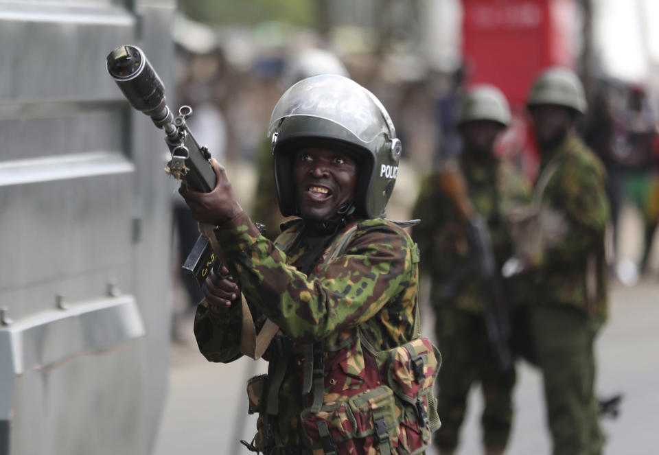 FILE - A policeman fires tear gas in the Kibera slums as police clash with demonstrators during a protest by supporters of Kenya's opposition leader Raila Odinga over the high cost of living and alleged stolen presidential vote, in Nairobi, on March 20, 2023. The United States is praising Kenya's interest in leading a multinational force in Haiti. But weeks ago, the U.S. openly warned Kenyan police officers against violent abuses. Now 1,000 of those police officers might head to Haiti to take on gang warfare. (AP Photo/Brian Inganga, File)