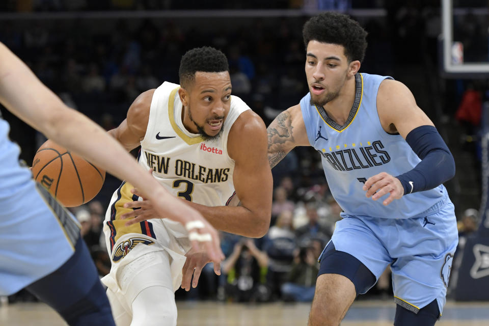 New Orleans Pelicans guard CJ McCollum (3) drives against Memphis Grizzlies guard Scotty Pippen Jr., right, in the first half of an NBA basketball game Monday, Feb. 12, 2024, in Memphis, Tenn. (AP Photo/Brandon Dill)