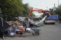 Police use a crane to remove tents and other stuff from outside the residence of former Prime Minister Imran Khan during a search operation in the Khan's resident, in Lahore, Pakistan, March 18, 2023. Pakistani police stormed former Prime Minister Khan's residence in the eastern city of Lahore on Saturday and arrested 61 people amid tear gas and clashes between Khan's supporters and police, officials said. (AP Photo/K.M. Chaudary)