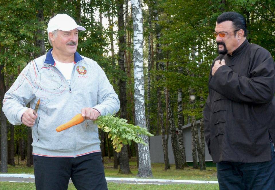 Belarus president Alexander Lukashenko peels a carrot before handing it to US action star Steven Seagal, who was visiting his country residence (AFP Photo/Stasevich Andrei Olegovich)