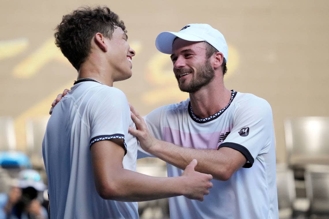 Tommy Paul, right, of the U.S. is congratulated by compatriot Ben Shelton following their quarterfinal match at the Australian Open tennis championship in Melbourne, Australia, Wednesday, Jan. 25, 2023.(AP Photo/Dita Alangkara)