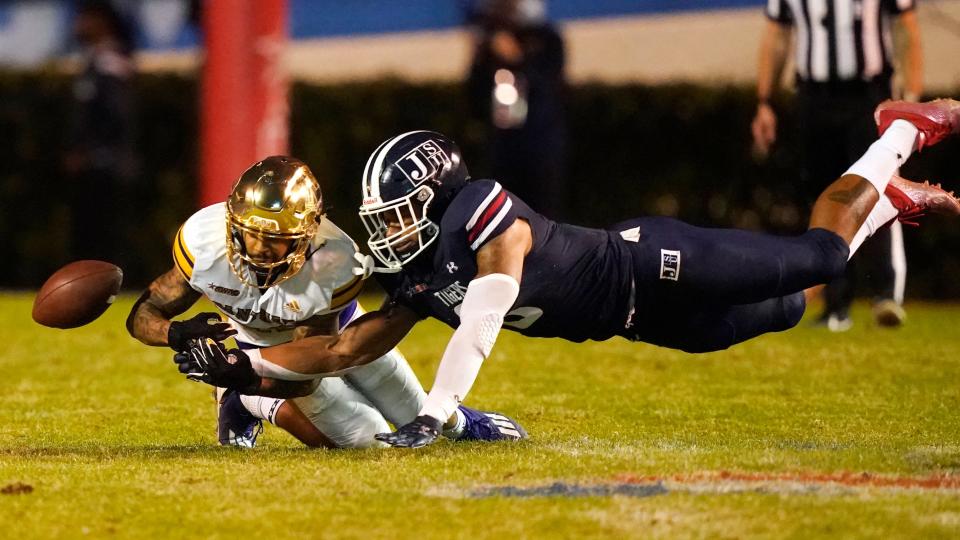 Jackson State defensive back John Huggins (6) knocks the ball away from Prairie View wide receiver Jailon Howard (82) during the second half of the Southwestern Athletic Conference championship NCAA college football game Saturday, Dec. 4, 2021, in Jackson, Miss. Jackson State won 27-10. (AP Photo/Rogelio V. Solis)