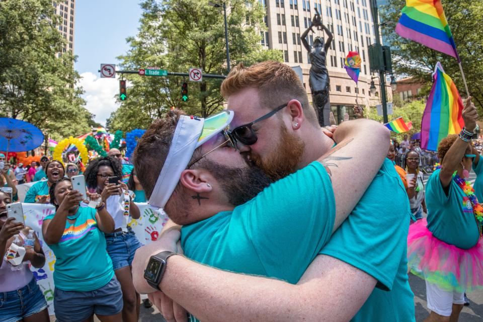 Justin and Bren Hipp of Albemarle embrace at a Charlotte Pride parade in 2019. This photo was removed from the county museum in June 2022.