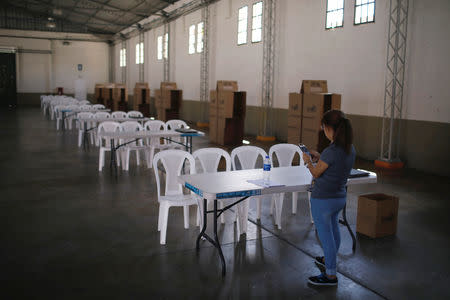 Electoral worker checks a polling station at the International Fairs and Convention Center in San Salvador, El Salvador February 2, 2019. REUTERS/Jose Cabezas