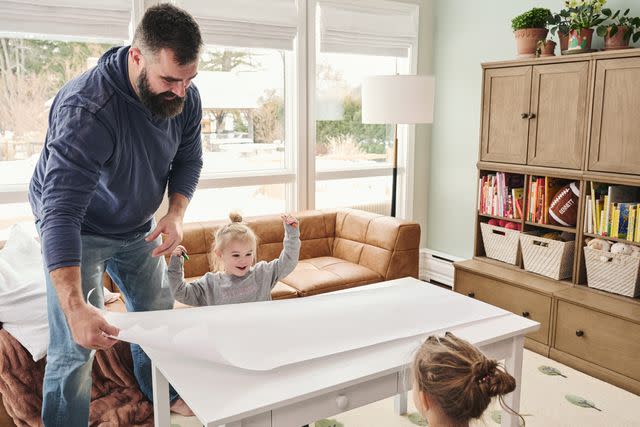 <p>courtesy of Pottery Barn Kids</p> Jason Kelce puts down drawing paper for daughters Elliotte and Wyatt