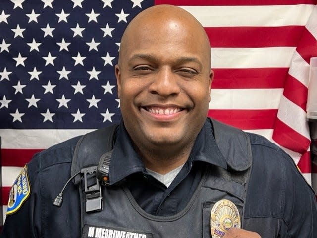 Marlboro Township Officer Marc Merriweather carried a woman from her burning home on Sunday morning, minutes before the structure was engulfed in flames.