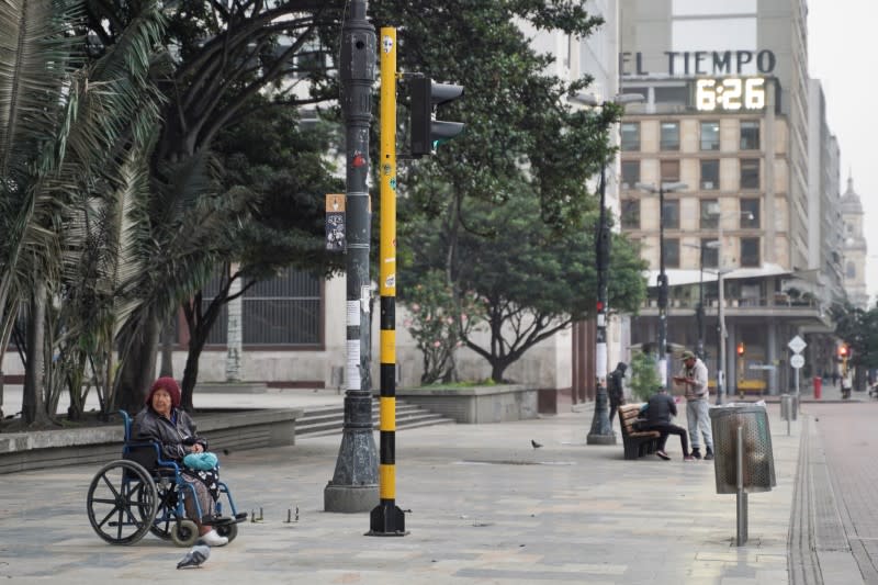A woman in a wheelchair is seen on a lonely street during the four-day mandatory isolation decreed by the mayor of Bogota, as a preventive measure against the spread of the coronavirus disease (COVID-19), in Bogota