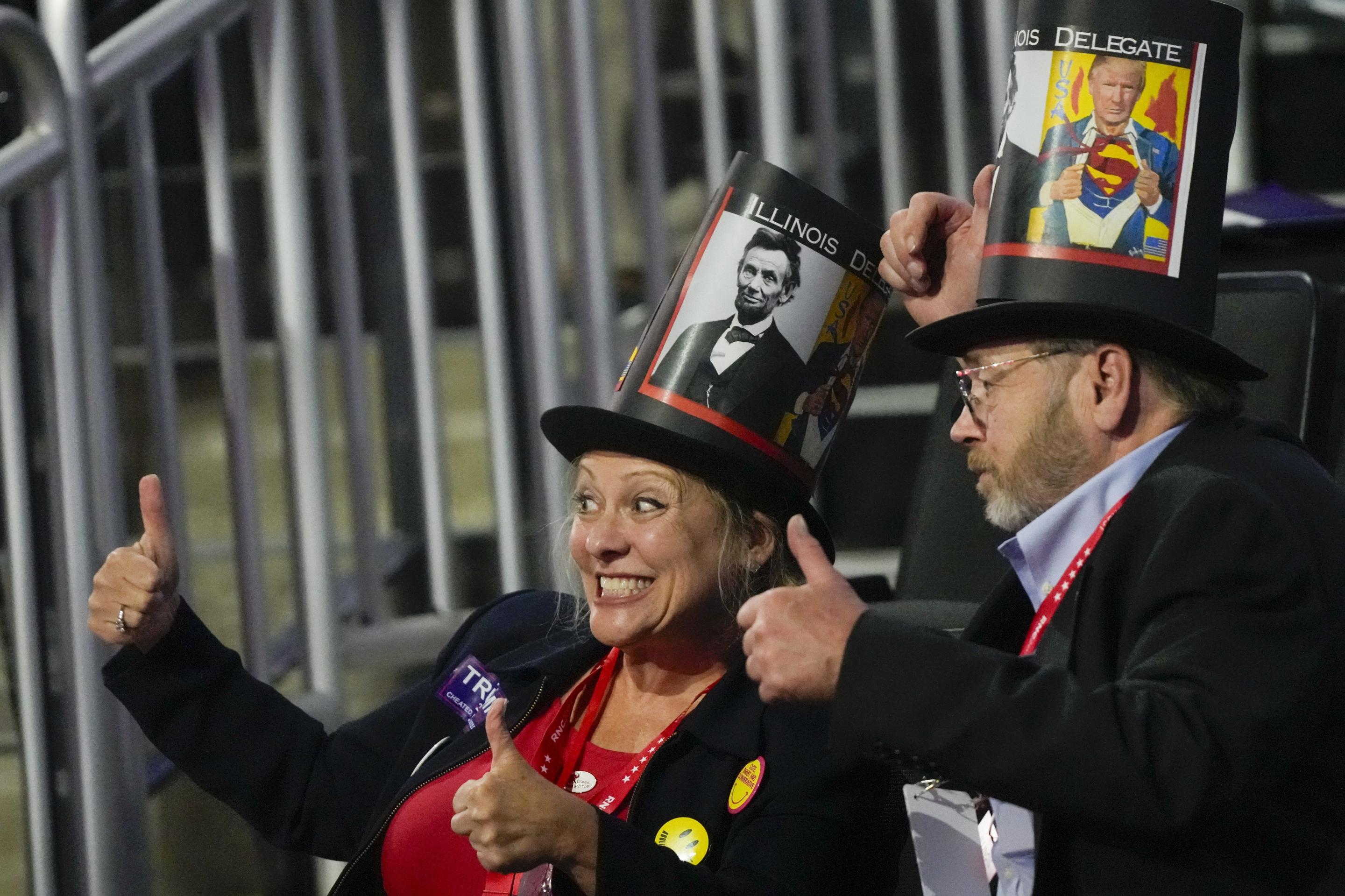 Supporters pose for a picture with hats depicting former Presidents Donald Trump and Abraham Lincoln.