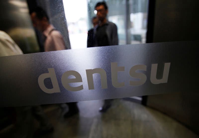 FILE PHOTO: The logo of Dentsu Co. is seen at the entrance of the company headquarters in Tokyo