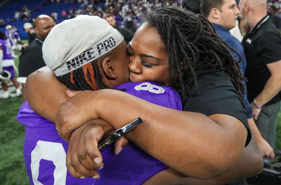 Ben Davis Giants linebacker Nylan Brown (8) hugs his mother Domonique Brown on Saturday, Nov. 25, 2023, during the IHSAA Class 6A football state championship game at Lucas Oil Stadium in Indianapolis. The Ben Davis Giants defeated the Crown Point Bulldogs, 38-10.