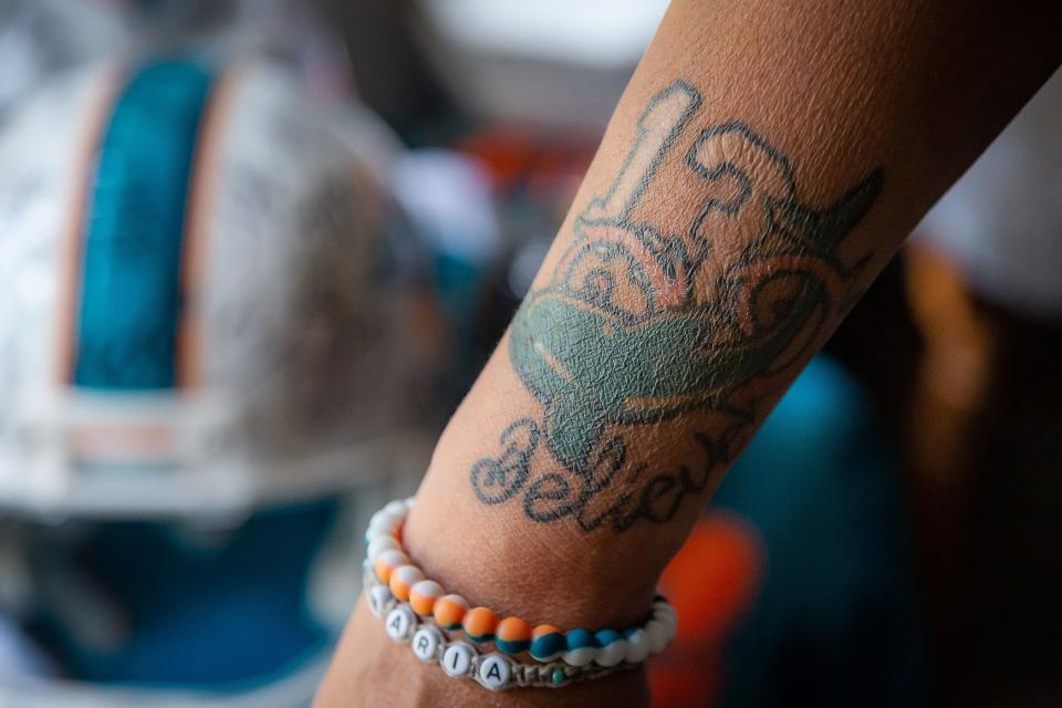 Miami Dolphins fan Maria Caraballo, from  Loxahatchee, has tattoos dedicated to her favorite football team.