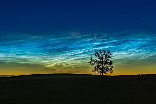 This view of noctilucent clouds is seen on June 16 in southern Alberta. The display lasted until dawn, according to photographer Alan Dyer.   (Submitted by Alan Dyer/AmazingSky.com - image credit)