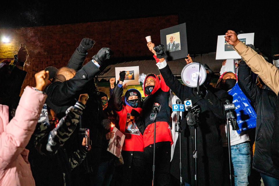 A crowd raises their fists around Karissa Hill during a candlelight vigil for her father Andre Hill, an unarmed Black man who was shot and killed by a Columbus police officer, in Columbus, Ohio on Dec. 26, 2020.<span class="copyright">Stephen Zenner—AFP/Getty Images</span>