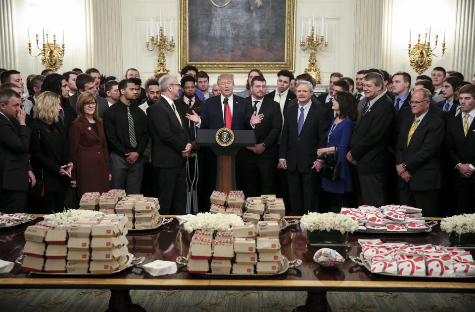 WASHINGTON, DC - MARCH 4:  (AFP OUT)  U.S. President Donald Trump speaks behind a table full of McDonald's hamburgers, Chick fil-a sandwiches and other fast food as he welcomes the 2018 Football Division I FCS champs North Dakota State Bison in the Diplomatic Room of the White House on March 4, 2019 in Washington, DC. (Photo by Oliver Contreras-Pool/Getty Images)