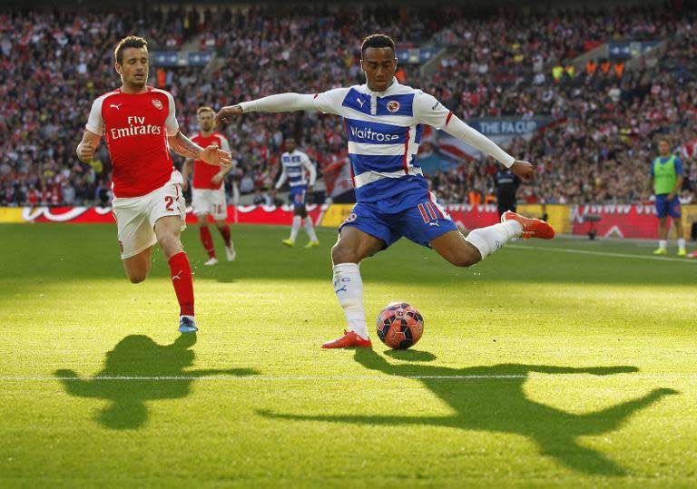 Reading's midfielder Jordan Obita (R) attempts a cross by Arsenal's French defender Mathieu Debuchy during the FA Cup semi-final between Arsenal and Reading at Wembley stadium in London on April 18, 2015